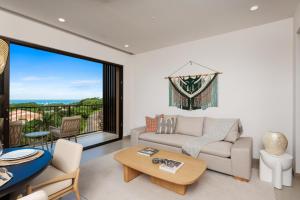 a living room with a couch and a table at Costa Elena at Naumi, Ocean Views & Beach Club in Sardinal +16 photos