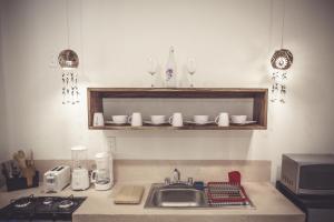 a kitchen with a sink and a counter with glasses at Aldea San Lam - Oasis Of Tulum in Tulum