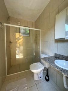 a bathroom with a toilet and a sink at Caiçara's house in Praia de Araçatiba