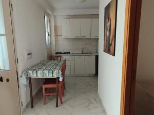 a small kitchen with a table and a sink at Canto delle Rane in Vieste +36 photos
