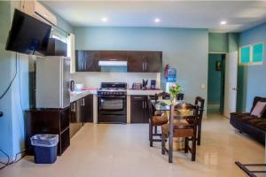 a kitchen with a couch and a table in a room at Casa las Flores in Puerto Vallarta