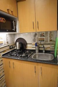a kitchen with a sink and a microwave at Midtown Studio near Tahrir in Cairo