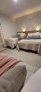 a bedroom with three beds and a ladder at Espaço Harmonia - um apartamento inteiro e aconchegante para vc! in Curitiba