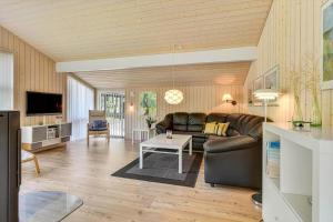 a living room with a couch and a table at BV406-Blavand-Tvaervaenget-2 in Blåvand