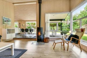a living room with a fire place in the middle at BV406-Blavand-Tvaervaenget-2 in Blåvand