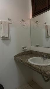 a bathroom with a sink and a mirror at Ocean Praia Hotel in Fortaleza