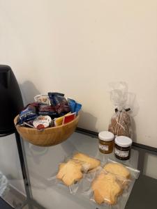 a glass table with a basket of food and jars of food at La Chianconata Rooms in Vieste