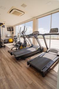 a gym with three tread machines in a room at Crocobeach Hotel in Fortaleza