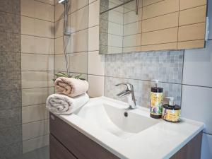 a bathroom with a sink with towels on it at Apartments Maestral in Trpanj +130 photos