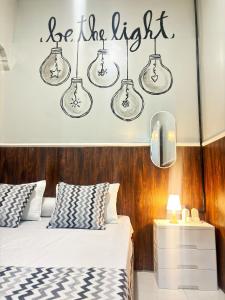 a bedroom with a bed and a sign that reads be the light at Semarang CoStay in Alastuwo +94 photos