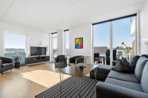 a living room with a couch and a table at 0274-Romo-Nordre-Havnevej-42 in Havneby