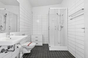 a bathroom with a toilet and a shower and a sink at 0274-Romo-Nordre-Havnevej-42 in Havneby +17 photos