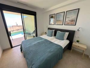 a bedroom with a bed and a view of a pool at House with Private Spa and Pool, with access to Sauna and Gym in Torrox Costa