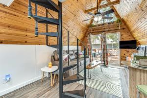 a spiral staircase in the living room of a house at Cozy Cabin with Deck and Boat Launch Access in Lampe! in Lampe