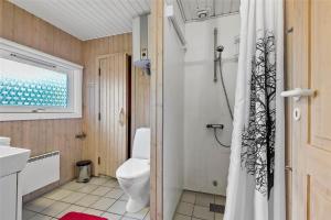 a bathroom with a toilet and a shower curtain at BV195-Vejers-Strand-Jafdalvej-51 in Vejers Strand +24 photos