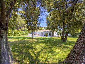 a yard with trees and a house in the background at Charming Casa Encinar in Tranquil Residential Area in Sa Pobla