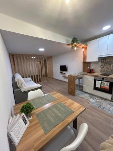 a living room with a table and a kitchen at Can Sablet in Horta de San Joan
