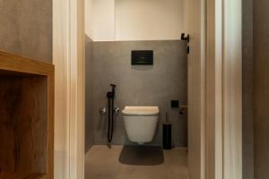 a bathroom with a white toilet in a room at The View Premium Villas in Perdika +11 photos