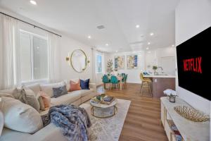 a living room with a couch and a table at Luxury Resort Pool Spa Arcade Movie Gym in Mission Viejo