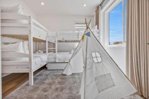 a bedroom with two bunk beds and a play tent at Luxury Resort Pool Spa Arcade Movie Gym in Mission Viejo