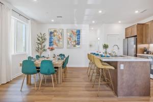 a kitchen with a table and green chairs in a room at Luxury Resort Pool Spa Arcade Movie Gym in Mission Viejo