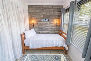 a bedroom with a bed and a sign on the wall at NEW! Large 1BR at The Golf Colony at Baytree, Pool in Stephens Crossroads +21 photos