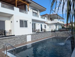 a swimming pool in front of a house at RelaxVila Ksamil in Ksamil