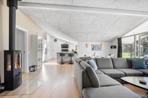 a living room with a couch and a fireplace at BV294-Blavand-Gronnevaenget-42 in Blåvand