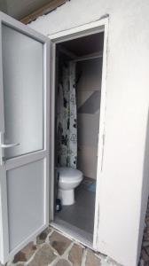 an open door to a bathroom with a toilet at Krnovo Mountain Lodge in Kruševice