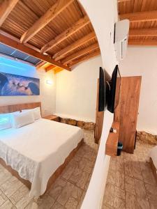 a bedroom with a bed and a flat screen tv at Ados Hotel in Cesme