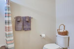 a bathroom with a toilet and towels on a wall at 14 Mi to Ark Encounter Rural Corinth Escape! in Corinth