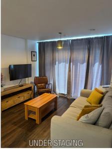 a living room with a couch and a table at Grover Court - Modern Stay with Free Gated Parking & WiFi in Kings Langley