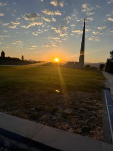 a sunset with the washington monument in the background at Modern Yerevan Apartment-Brand New in Yerevan