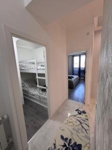 a mirror in a room with a bed and a bedroom at Modern Yerevan Apartment-Brand New in Yerevan