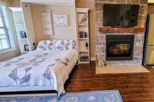 a bedroom with a bed and a fireplace at Riverfront Gem in Townsend