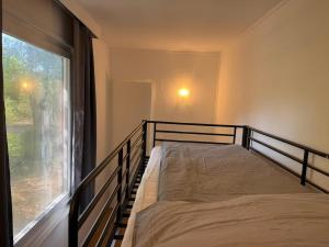 a bedroom with a bed and a large window at Feriendorf Seddiner See - Bungalow 1 in Seddin