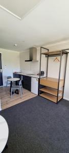 a kitchen with a table and a table and a table and a room at Hideaway of Rotorua in Rotorua