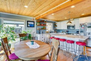 a kitchen with a wooden ceiling and a wooden table at Across Water From Belfair SP Hood Canal Cottage! in Belfair
