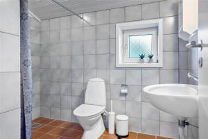 a bathroom with a white toilet and a sink at BV117-Vejers-Strand-Engesovej-34 in Vejers Strand +21 photos