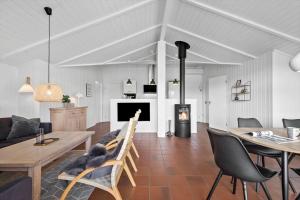 a living room with a couch and a table and a fireplace at BV117-Vejers-Strand-Engesovej-34 in Vejers Strand