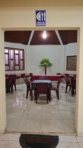 a dining room with tables and chairs in a building at Hostal Casa Habana in Managua
