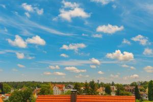 a blue sky with white clouds over a city at Haus Schömberg in Schömberg
