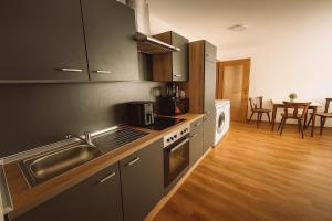 a kitchen with a sink and a stove top oven at Haus Schömberg in Schömberg