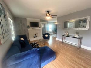 a living room with a blue couch and a table at Gated single family home downtown ST Petersburg, FL in St. Petersburg