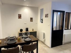 a dining room with a table with wine glasses on it at Studio Cosy Lezennes Decathlon Arena in Lezennes