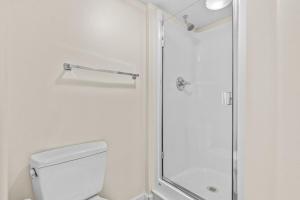 a white bathroom with a shower and a toilet at Emerald City Penthouse in Seattle +17 photos