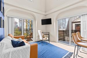 a man laying on a bed in a room with a balcony at Emerald City Penthouse in Seattle