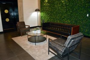 a lobby with a couch and a table and chairs at Ruelle 505 in Tijuana