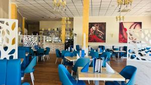 a dining room with blue chairs and tables at Casa Maria with Pool, Terace & Amazing View - near Beach, Golf, Town & Relax - 1-6 Guests in Rojales