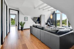 a living room with a large couch and a table at BV284-Blavand-Blavand-Strand-4 in Blåvand +64 photos